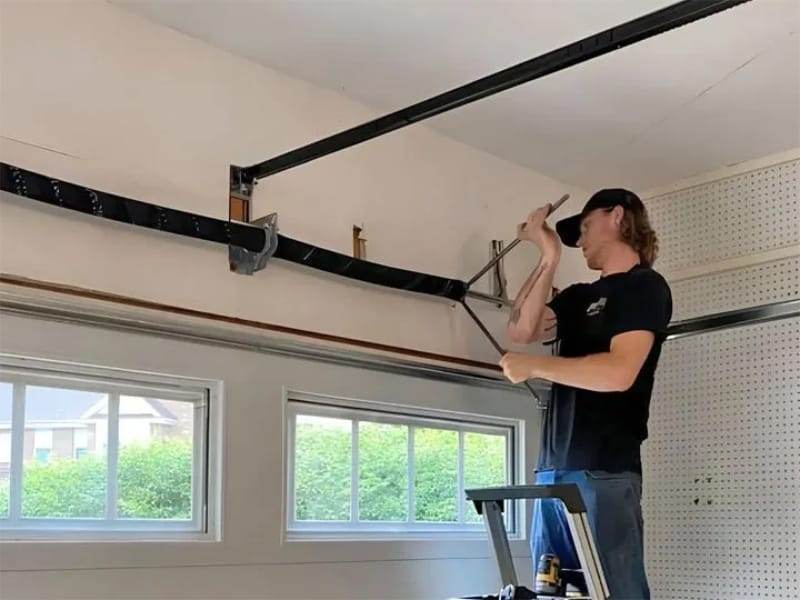 Gateway technician repairing a garage door
