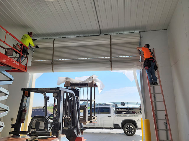 Gateway commercial team installing a new garage door