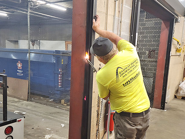 Gateway commercial team repairing a commercial garage door